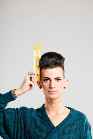 Aiming for perfectly level hair. a handsome young man standing alone in the studio and holding a...