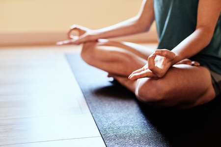 Lotus is life. a woman meditating in the lotus position during a yoga session.の写真素材