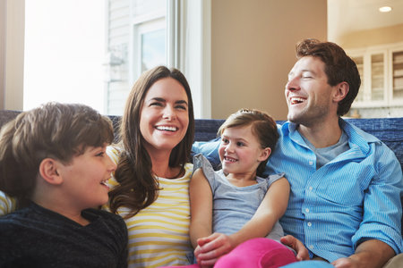 Quality time is essential for strengthening family bonds. a happy family bonding together at home.の写真素材