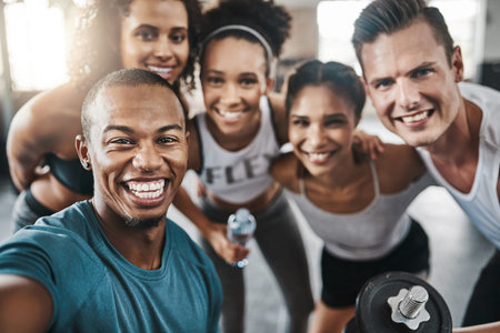 Celebrate a gym session with a selfie. a group of young people taking a selfie together during their...