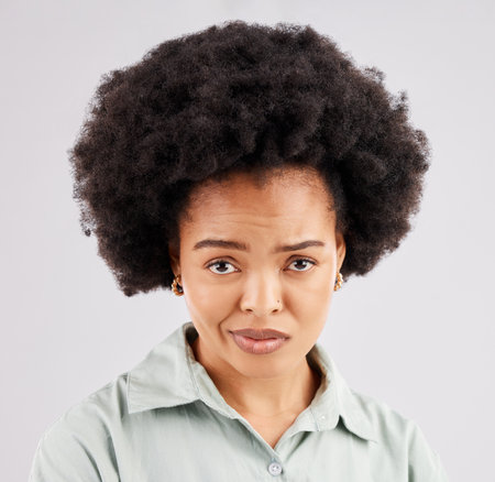 Confused, doubt and portrait of black woman in studio with puzzled, bored and annoyed facial expression. Emotions, mockup and girl on white background with bad attitude, unsure and disbelief faceの写真素材