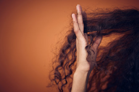 Mockup, closeup and woman with hair care, fingers and salon treatment for volume, texture and grooming. Zoom, female person and model with scalp massage, curls and beauty against a studio backgroundの写真素材