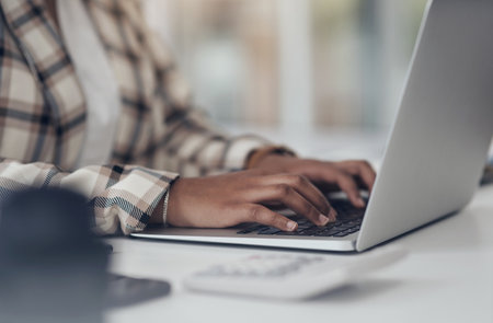 Laptop, typing and woman hands for online research, startup finance or budget management at her office desk. Financial planning, working and worker, employee or person on computer software or websiteの写真素材