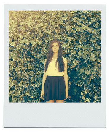 Dawning beauty. Portrait of an attractive teenage girl standing in the outdoors.の写真素材