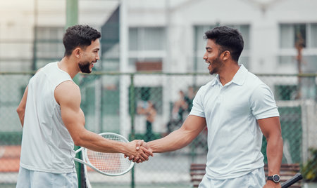 Happy man, tennis and handshake for fitness, partnership or deal in competition or game on court. Men or friends shaking hands for sports training, teamwork or support in friendly match or agreementの写真素材