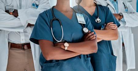 Group, doctors and arms crossed in hospital, teamwork and solidarity with women, men and support for healthcare. Doctor, team and people with stethoscope, medical collaboration and together in clinicの写真素材