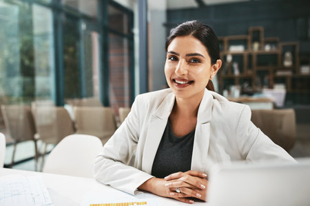 Heading towards greater entrepreneurial success. Portrait of a young businesswoman working in an office.の写真素材