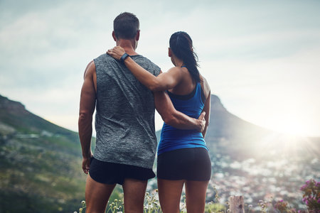 Getting fit with the most beautiful scenery. an unrecognizable couple training for a marathon outdoors.の写真素材