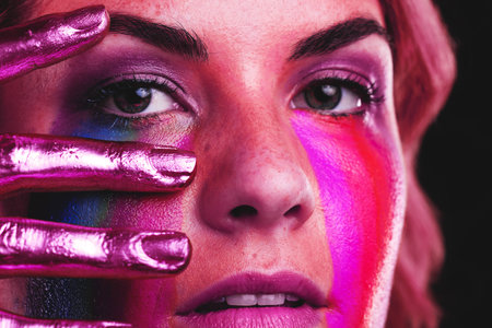 Woman, beauty portrait and metallic color paint or cosmetics on skin, hand and face in studio....