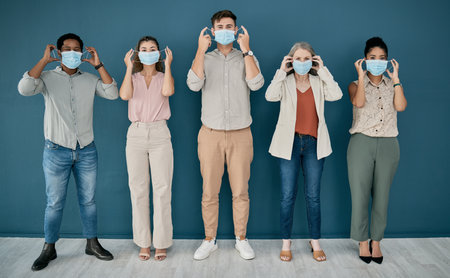 Covid, portrait and group of business people in office for health and safety. Teamwork, compliance and employees, men and women with face mask or ppe to stop corona virus for wellness in workplace.の写真素材