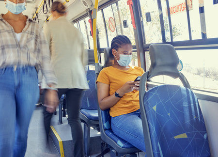 Travel, covid and woman on a bus with face mask for compliance, safety and bacteria protection in a...