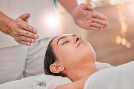 Woman, hands or relax reiki spa for stress management, headache relief or healthcare wellness in holistic clinic. Energy healer, man or mind chakra peace for sleeping patient and special effects glowの写真素材