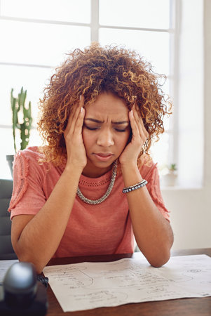 I cant take this anymore....a businesswoman looking stressed out at her desk.の写真素材