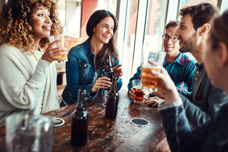 Theres only one way to start the weekend...a group of friends enjoying themselves at a bar.の写真素材