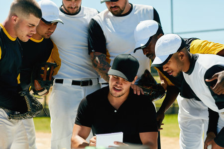Heres our plan for todays game...a group of young baseball players having a meeting with their coach on the field during the day.の写真素材
