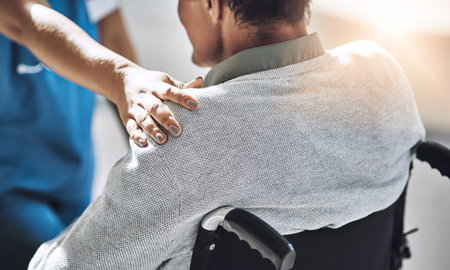 Youre not alone. a friendly medical practitioner assisting a handicapped patient.の写真素材