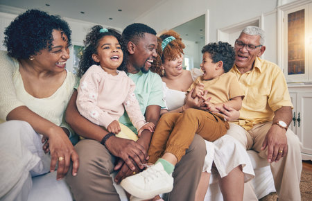 Black family laughing, portrait and living room sofa of a mother, father and children with grandparent. Happy, smile and bonding of a mom, dad and young kids together having fun with love and supportの写真素材