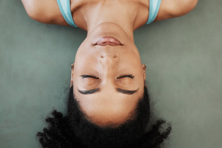 Black woman, yoga and meditation training, calm mindset and zen balance on the floor, top view and chakra. Female wellness, mental health and praying with freedom, mindfulness and relax with faithの写真素材