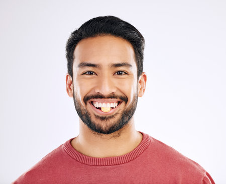 Vitamin pill, man and portrait with health supplement, prescription and wellness tablet. Isolated, studio background and male model face with nutrition, healthcare and healthy medication with a smileの写真素材