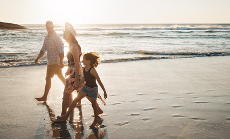 Out for a walk on the beach. a young couple spending the day at the beach with their daughter.の写真素材