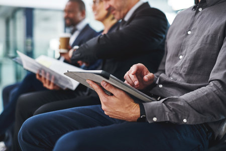 What does the internet say about preparing for an interview. a group of unrecognizable businesspeople sitting in line for an interview in a modern office.の写真素材