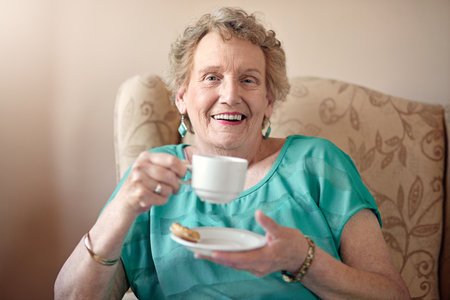 It takes a long time to get this sweet. a senior woman having a cup of coffee at home.の写真素材
