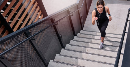 Put power into your every step. High angle shot of a sporty young woman running up a staircase...