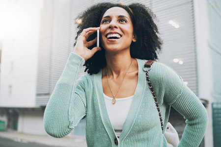 Phone call, communication and happy black woman in city talking, chat or dialogue. Conversation, travel and female from South Africa on 5g smartphone, mobile or cellphone speaking, chatting or talk.の写真素材