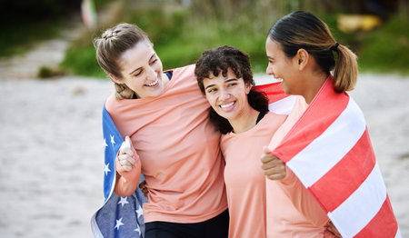 Friends, flag and usa with girls on the beach together during summer day for bonding in nature....