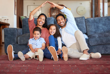 Insurance, house and portrait of family in living room for protection, policy and real estate. Roof, property and security with parents and children at home for support, investment and futureの写真素材