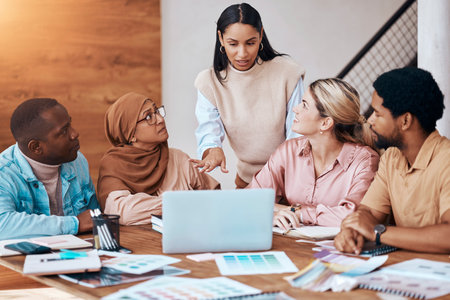 Meeting, strategy and business woman in a presentation talking and planning startup company data or paperwork. Diversity, discussion and group of people, team or employees brainstorming for teamworkの写真素材
