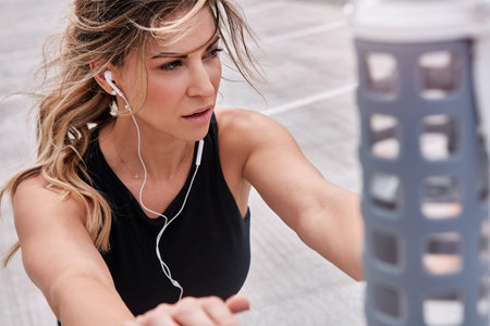 The only person youre fighting against is yourself. a sporty young woman stretching while exercising...