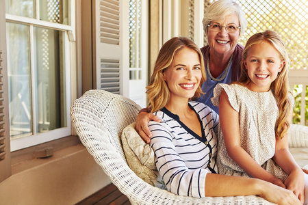 This is what its all about. Cropped portrait of a young girl sitting outside with her mother and...