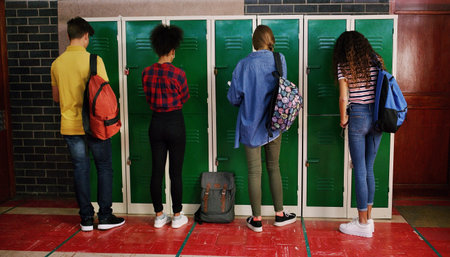 We all have our own lockers. Rearview shot of a group of school kids attending to their lockers...
