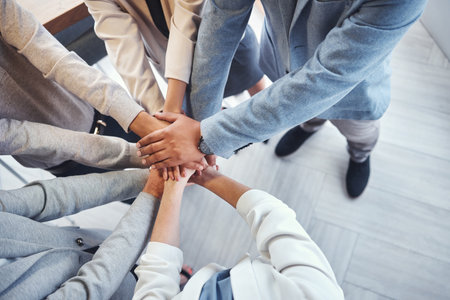Diversity, stack of hands and business people in the office in unity, collaboration and teamwork. Multiracial, corporate and professional team with motivation, support and connection in the workplaceの写真素材