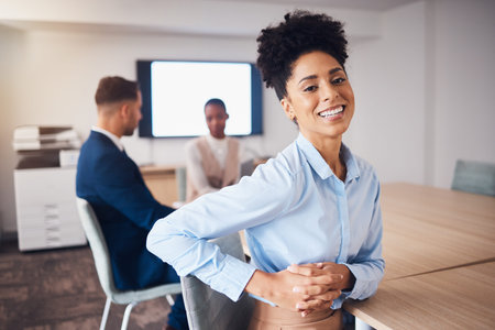Corporate, happy and portrait of a woman in a meeting, workshop or seminar with colleagues....