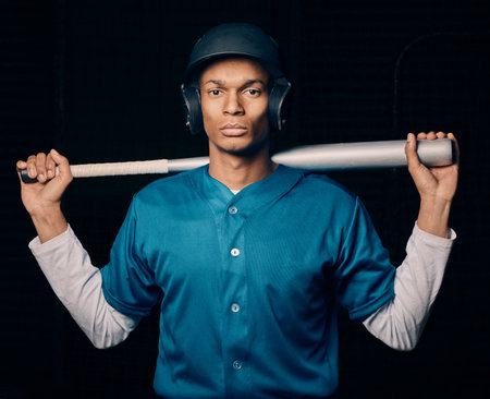 Sports, baseball and portrait of man with bat on black background ready for game, practice and competition. Fitness, sport mockup and serious male athlete for exercise, training and workout for matchの写真素材