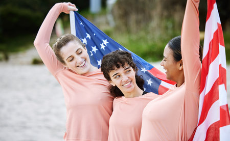 Volleyball woman, team and american flag at beach, happiness and pride for celebration, winning or goal. Women, sports and diversity with support, solidarity or teamwork for winner with excited smileの写真素材
