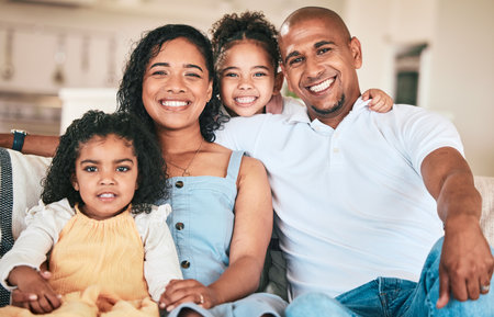 Family in portrait, parents and happy kids relaxing in home with support, love or bonding together on sofa. Happiness, people or living room with relationship and spending quality time on the weekendの写真素材