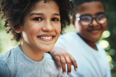 Lets just live in nature forever. two teenage boys exploring nature at summer camp.の写真素材