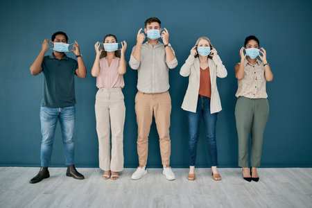 Portrait, covid and group of business people in office for health and safety. Teamwork, compliance and employees, men and women with face mask or ppe to stop corona virus for wellness in workplace.の写真素材