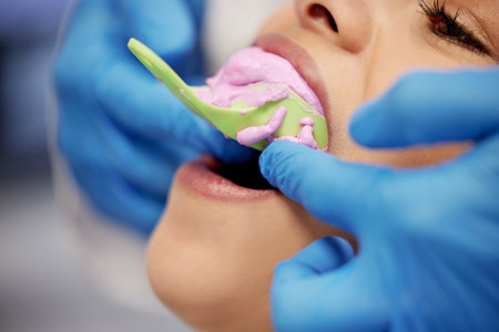 Finding the perfect fit. a young woman having dental work done on her teeth.の写真素材