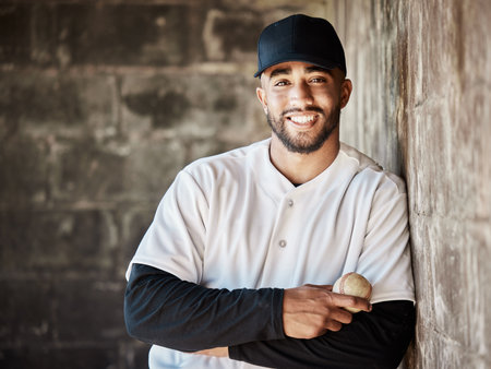Wall background, baseball and portrait of man with ball ready for game, match and practice in stadium. Softball mockup, sports and happy player smile in dugout for training, exercise and competitionの写真素材