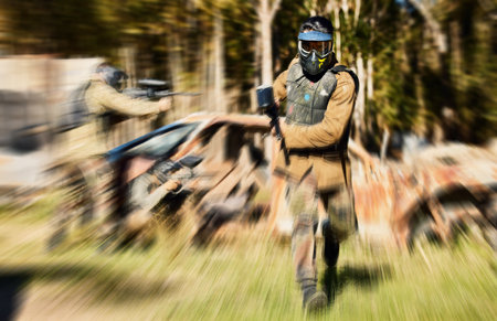 Soldier, paintball and running with gun for intense battle or war in the forest pushing to attack. Active paintballer rushing or moving fast in extreme adrenaline team sport with weapon or camouflageの写真素材