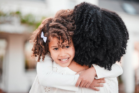 Portrait of girl hugging mother for love, affection and bonding in garden for relaxing, quality time and care outdoors. Family, smile and mom in child embrace on summer vacation, weekend and holidayの写真素材