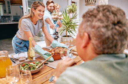 Thanksgiving, celebration and family serving food, having lunch together in family home. Grandparents, parents and child ready to eat turkey on holiday, festival and vacation, celebrating traditionの写真素材