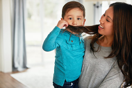 This is what daddy looks like when he hasnt shaved. a cute little boy playfully covering his mouth...