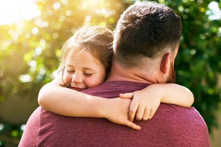 Dads bear hugs are the best. an adorable little girl giving her father a hug outdoors.の写真素材