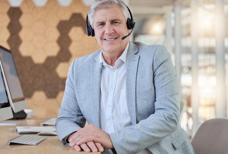Callcenter, smile and portrait of senior man with headset, computer and confidence in consulting office. Ceo, help desk and mature businessman at advisory agency, contact us and crm networking onlineの写真素材