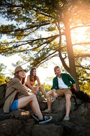 The sun shines on those who let it. three young people hiking while on an overseas trip.